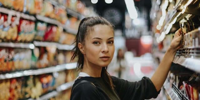 Woman browsing in supermarket aisle